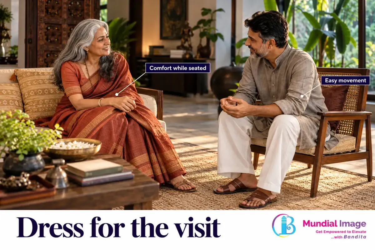 Two adults in understated Indian clothing seated for a relaxed home visit.