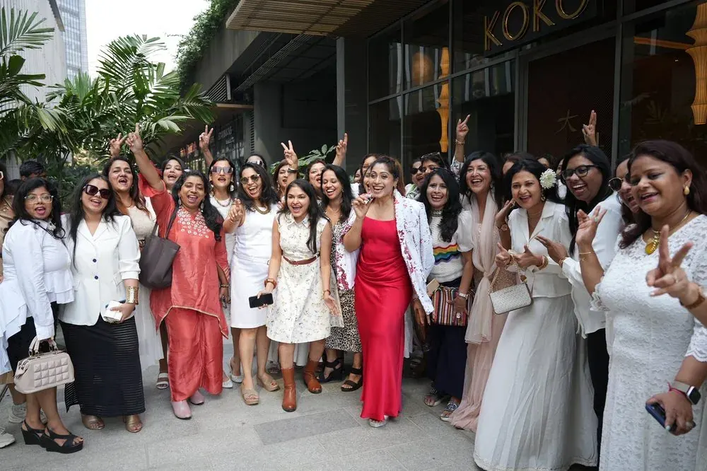 Edition II in Mumbai, members in red and white.