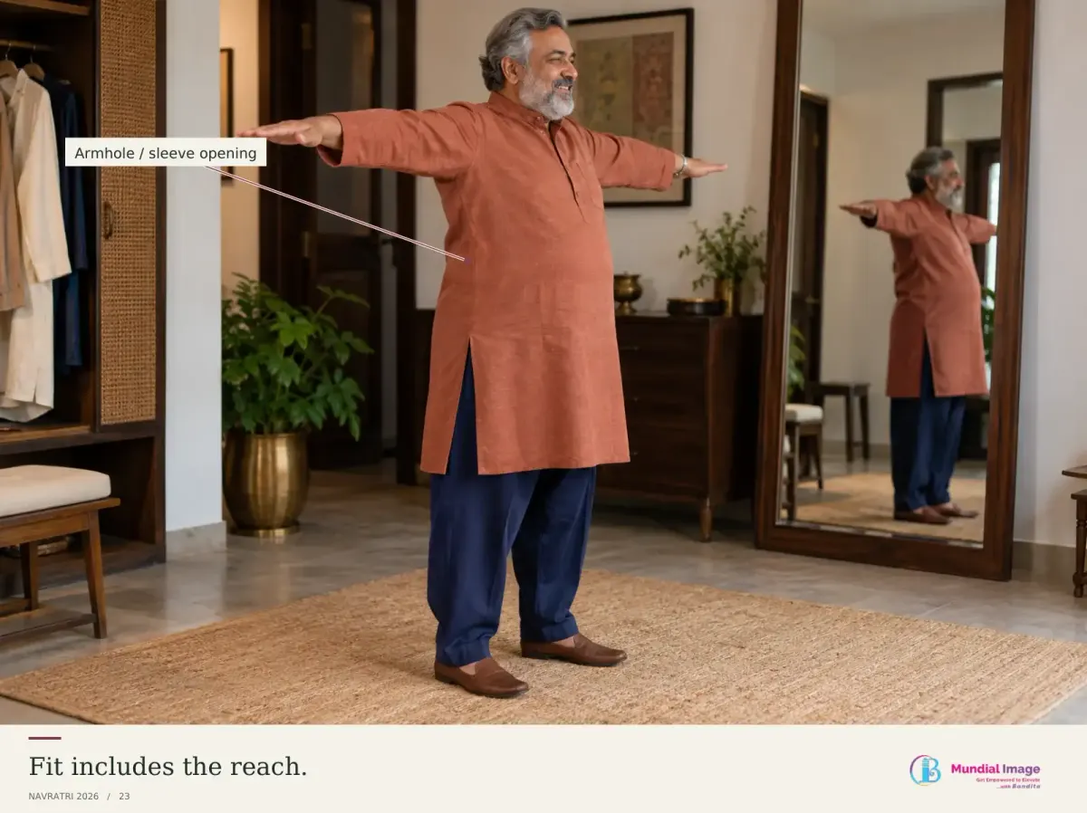 Indian man lifting his arms comfortably in a kurta and roomy trousers.